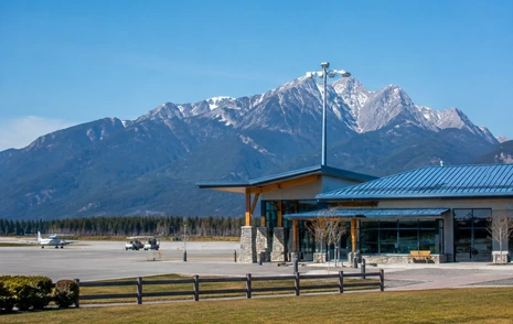 A regional airport terminal with an open apron and mountains behind, Abbotsford BC
