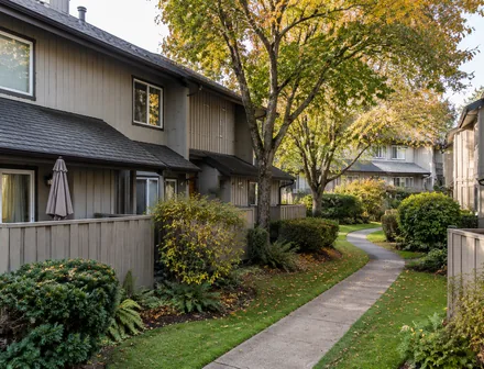 An older townhome complex with landscaped walkways, townhomes for sale in Aldergrove, Langley