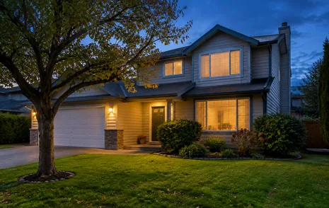 A 2 storey detached family home lit at dusk, houses for sale in Aldergrove Langley