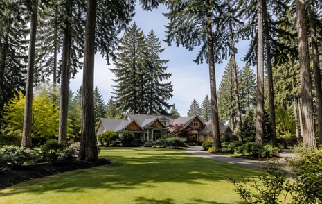 A large treed residential lot with a detached house set well back from the road in Brookswood, Langley BC