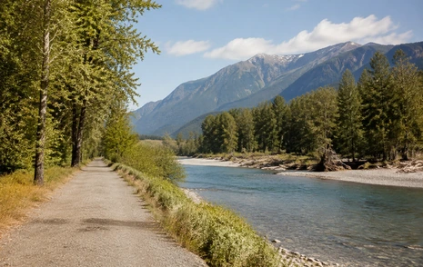A gravel trail beside the Vedder River with mountains behind, Chilliwack BC