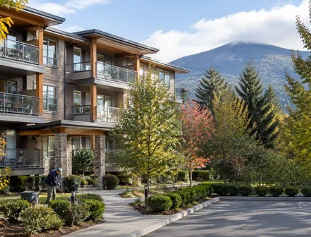 A low rise condo building with balconies and mature trees, condos for sale in Abbotsford BC