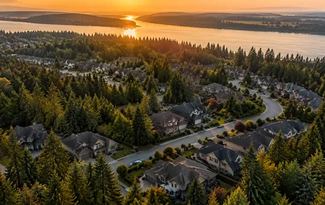 Rooftops of detached family homes among tall evergreens in Fraser Heights, Surrey BC
