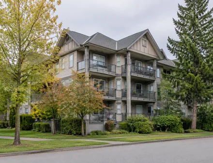 A low rise condo building among mature trees, condos for sale in Murrayville, Langley
