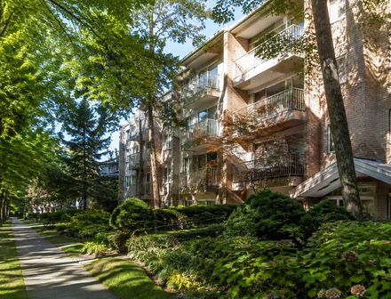 A four storey condo building with glass balconies, condos for sale in Newton, Surrey